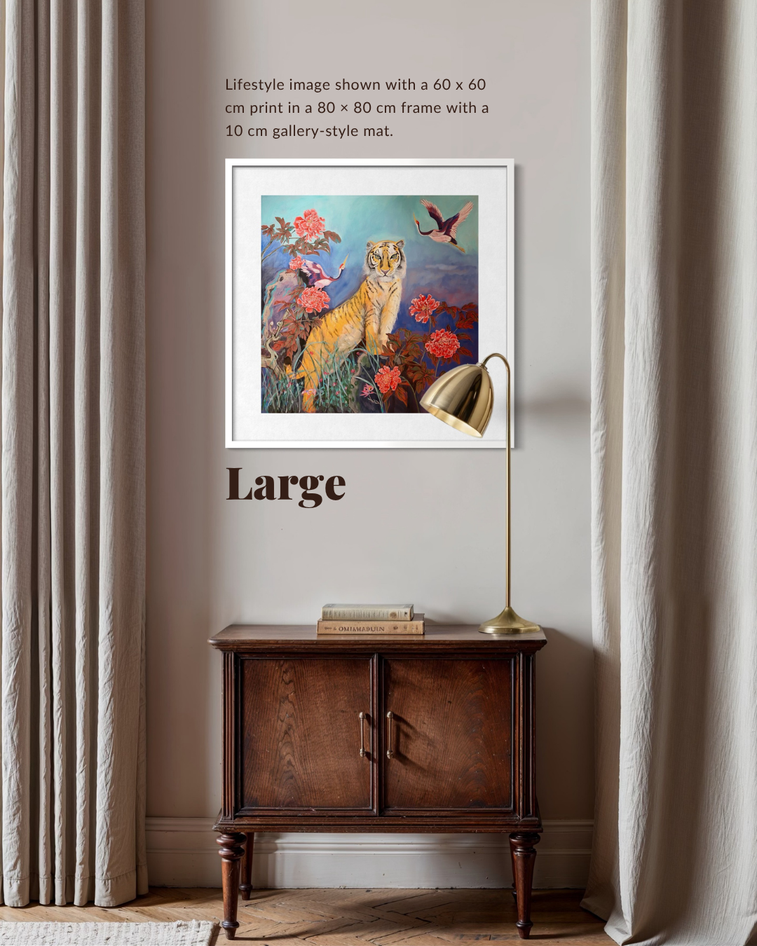 A framed art print featuring a colorful tiger and birds is displayed on a beige wall above a dark wood cabinet, with curtains on both sides and a floor lamp. Text at the top describes the print size as 60 x 60 cm in an 80 x 80 cm frame with a 10 cm gallery-style mat.