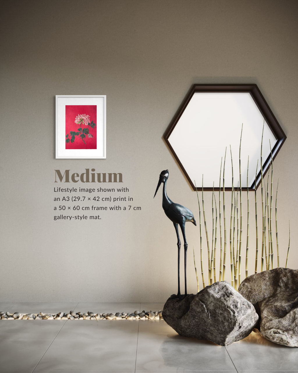 A framed wall art print with a red floral design is shown in a styled interior setting with a hexagonal mirror, a black heron sculpture, tall bamboo-like stems, and large rocks on a tiled floor. Text on the wall reads 'Medium' and describes the print size and frame.