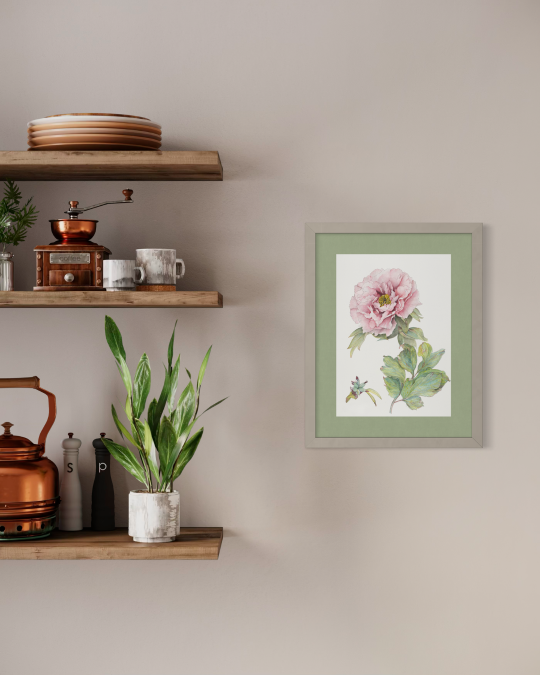 A framed botanical art print featuring a pink flower and green leaves, displayed on a beige wall next to wooden floating shelves with home decor.