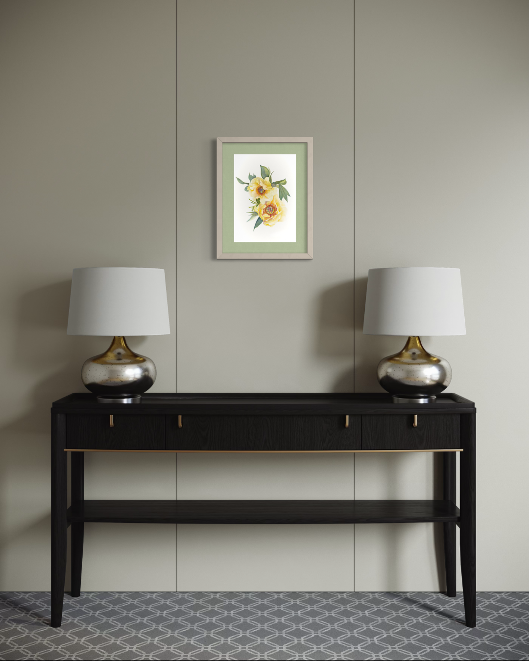 A framed floral art print hangs on a light beige paneled wall above a black console table with two matching table lamps, one on each side.