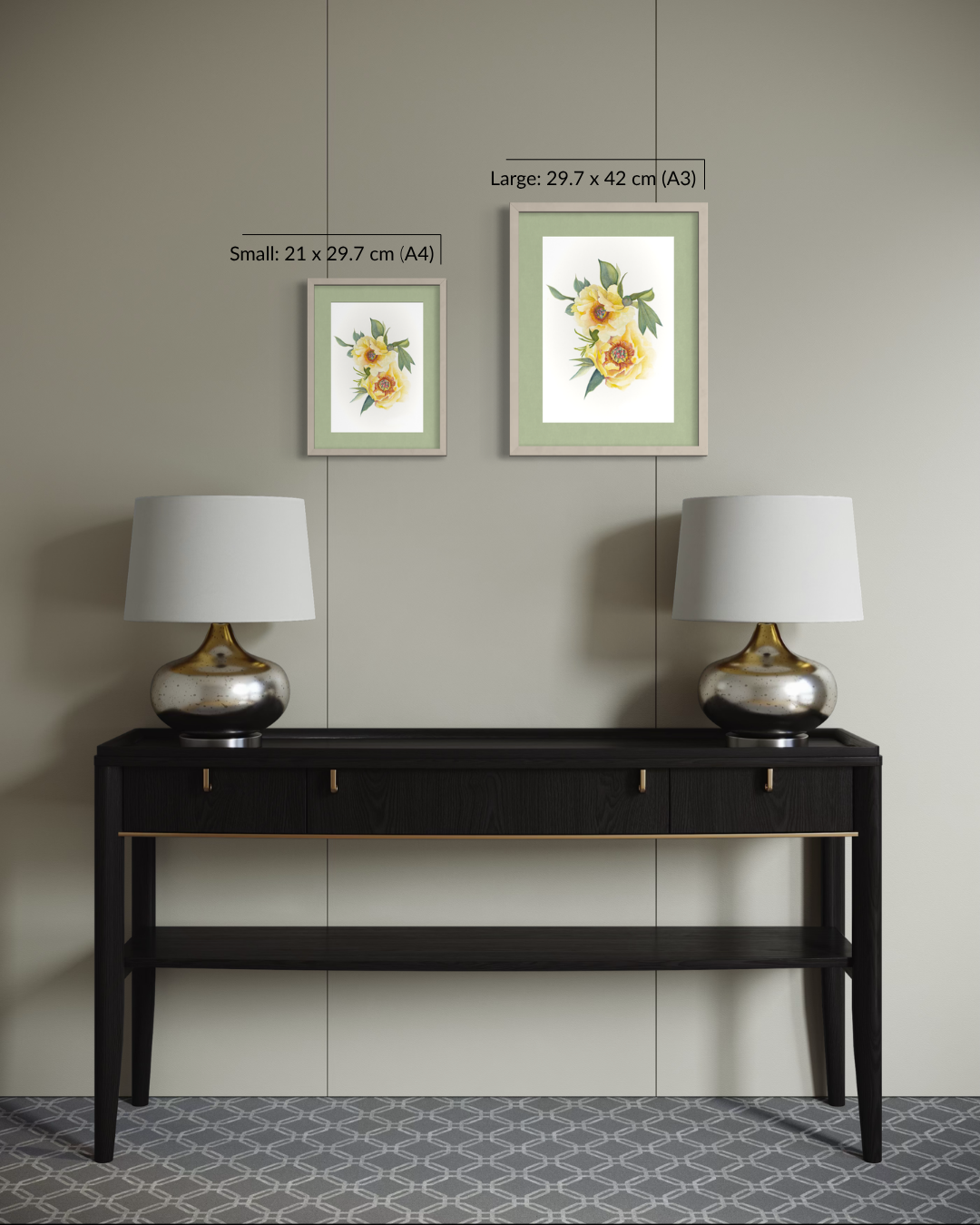 Two framed floral art prints displayed on a beige wall above a dark wood console table with two silver lamps. The image includes size labels for the prints: Small 21 x 29.
