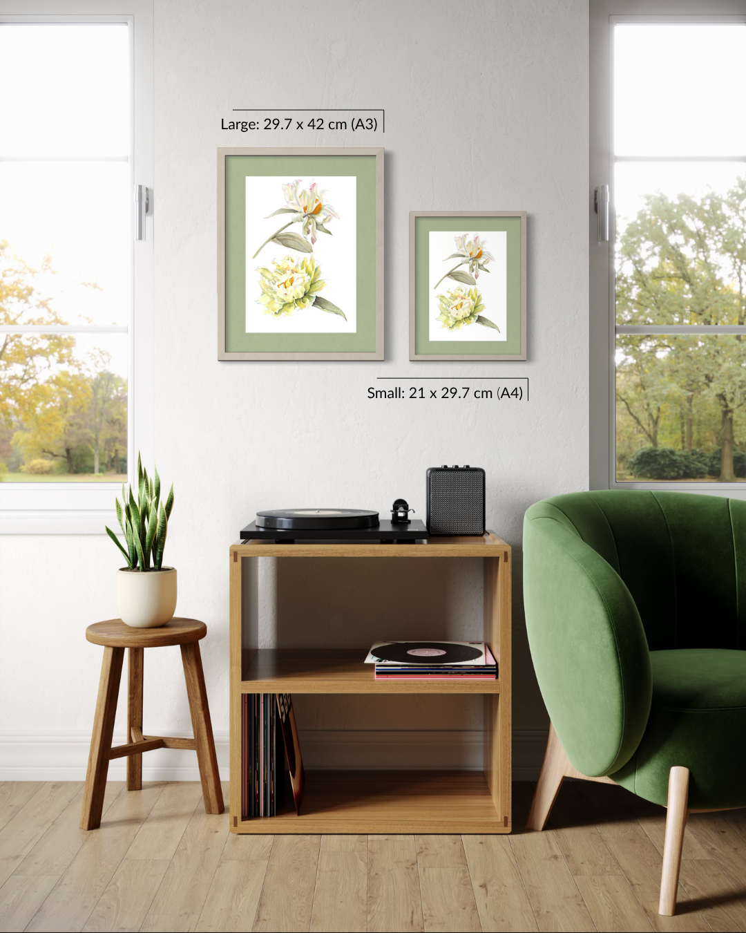 Two framed botanical art prints with white flowers and green leaves are displayed on a light gray wall in a styled room. One print is labeled as large (29.