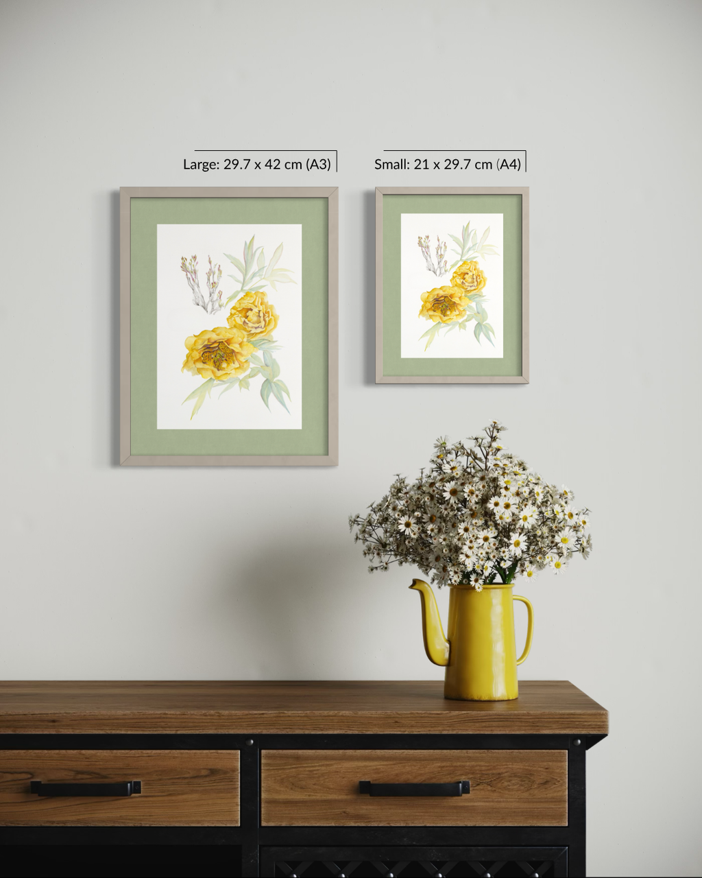 Two framed floral art prints hang on a light gray wall above a wooden console table. The left print is labeled 'Large: 29.