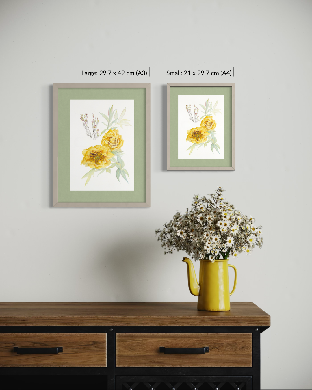 Two framed floral art prints hang on a light gray wall above a wooden console table. The left print is labeled 'Large: 29.