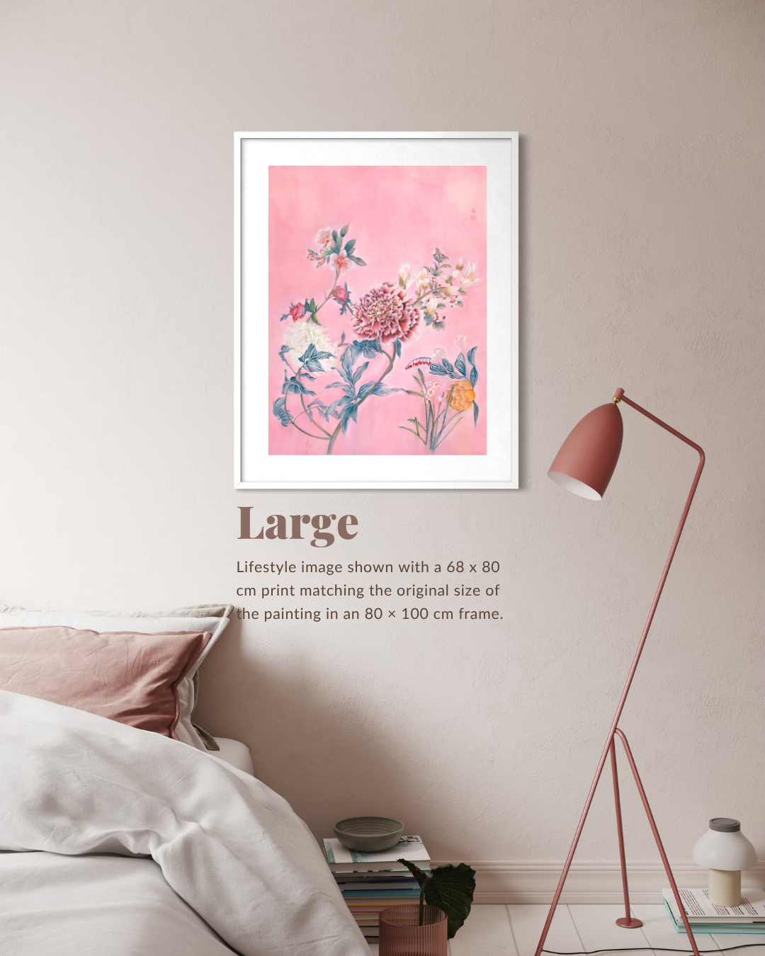 A framed floral art print with a pink background hangs on a beige wall above a bed in a styled bedroom. The print shows blue, white, and orange flowers with botanical details.