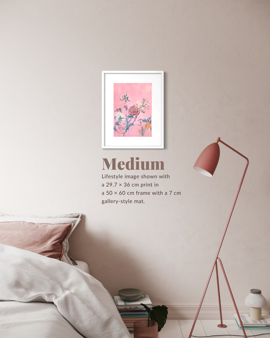 A framed floral art print with a pink background hangs on a beige wall above a bed, with a pink floor lamp nearby. Text below reads 'Medium' with lifestyle image details.