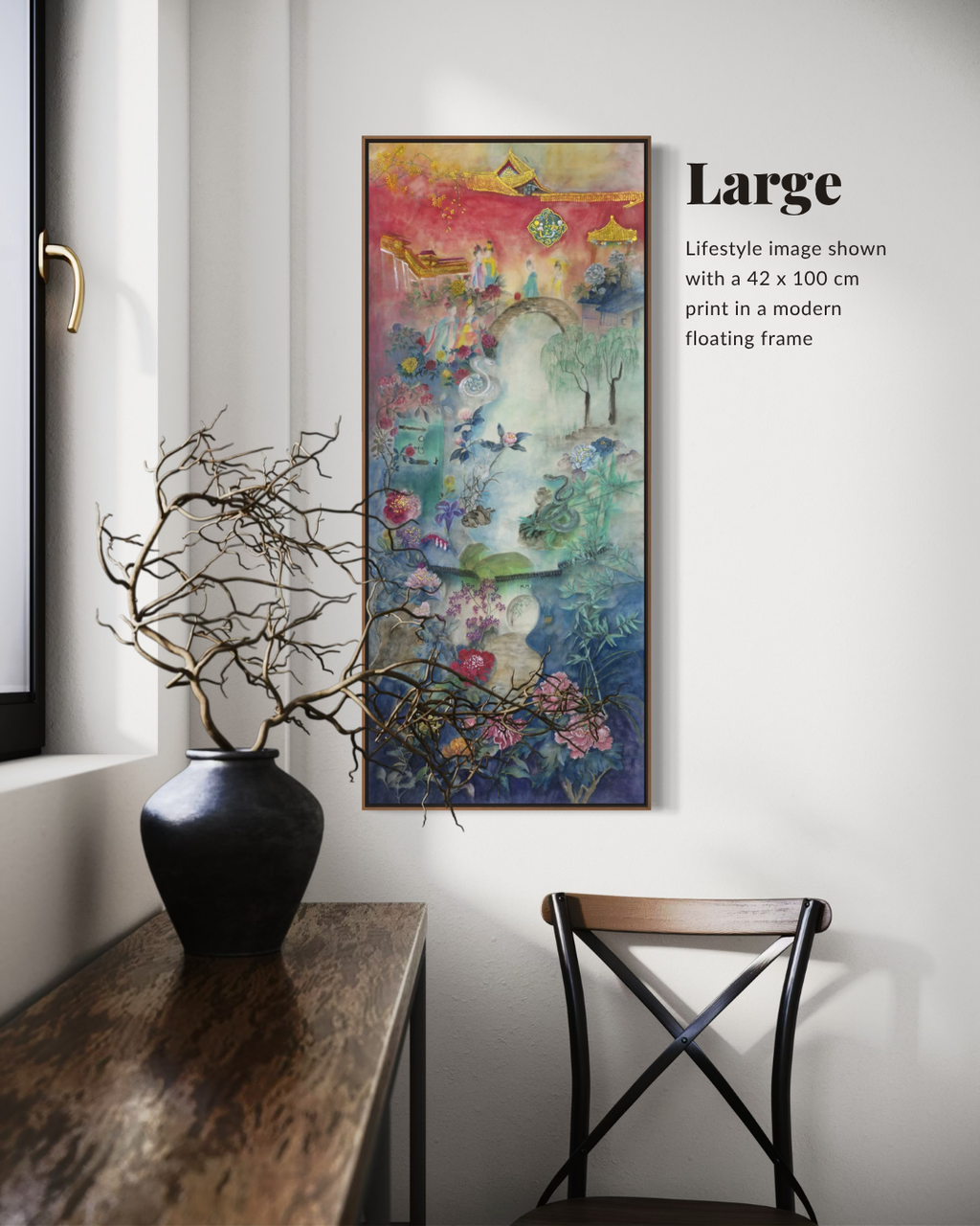 A framed vertical art print hangs on a white wall in a styled interior. The artwork is highly colorful with abstract landscape-like imagery in pink, yellow, blue, green, and purple tones.