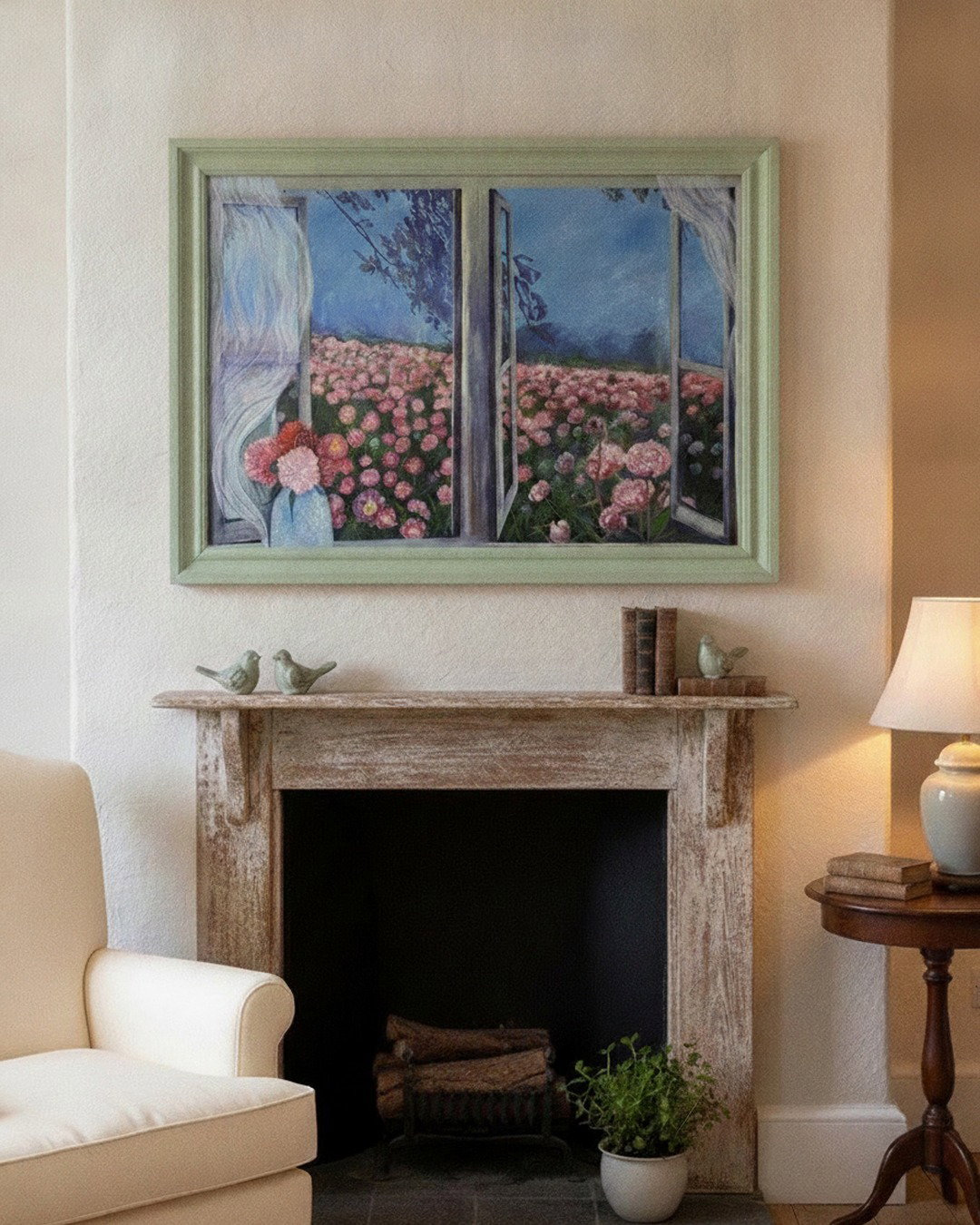 A framed art print depicting a girl in a pink flower field seen through an open window, hung on a beige wall above a rustic fireplace in a cozy living room setting.