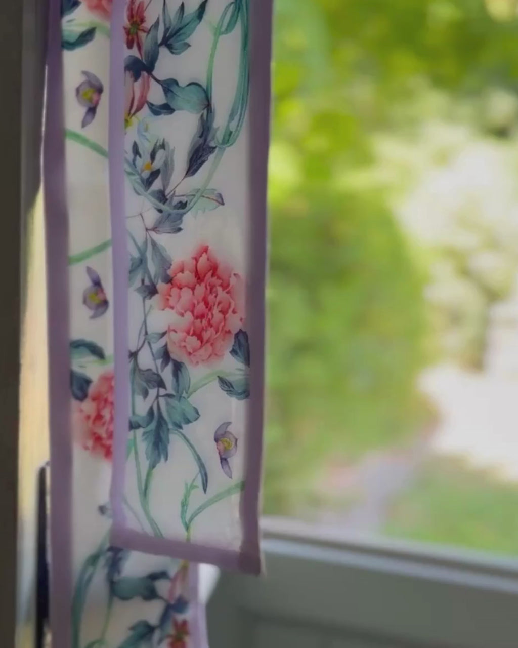 Purple ribbon scarf flowing in the breeze by the cottage door